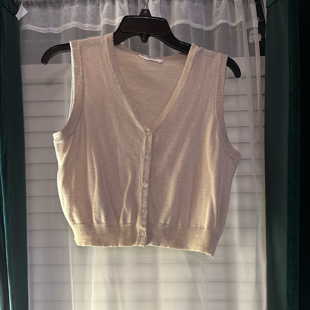 Medium, cream colored cropped button up vest.
